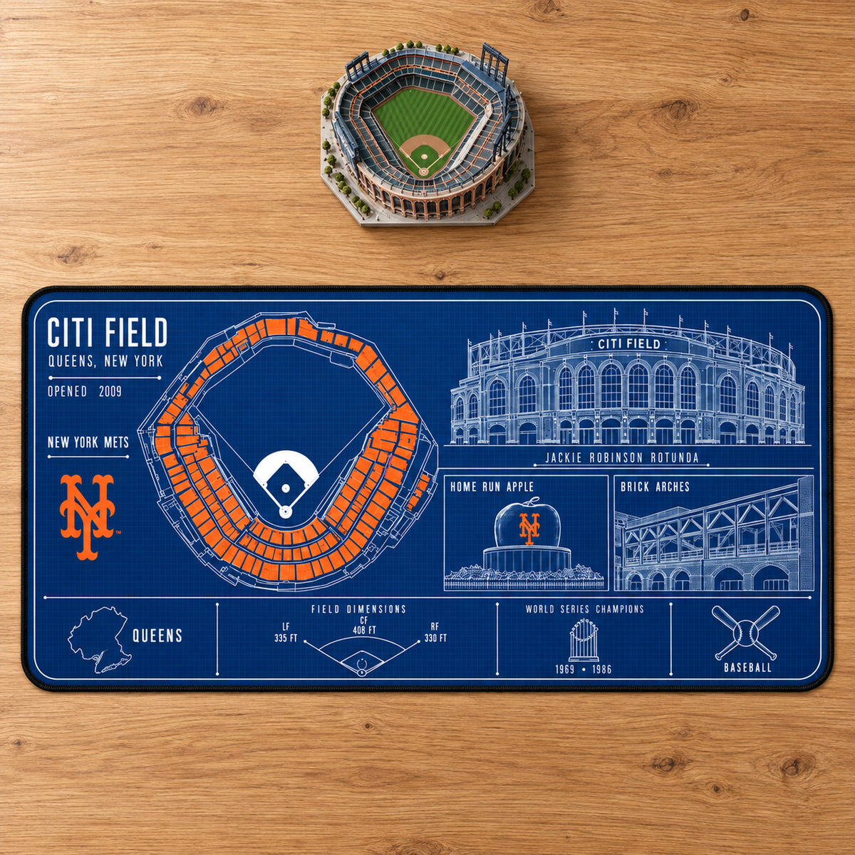 New York Mets Citi Field blueprint desk mat, 16" x 32", on a wooden desk with a decorative stadium model